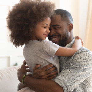 William Russell - International Income Protection - Affordable - Father happy hugging his daughter