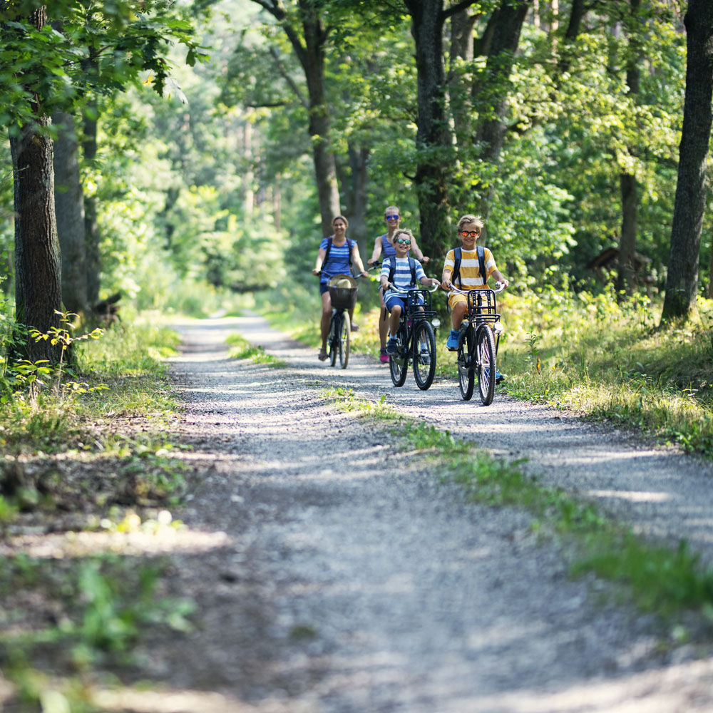 Family enjoying a bike trip together - Best Countries for Green Living for Expats