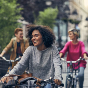 William Russell - International Income Protection - Affordable - friends riding bikes through city