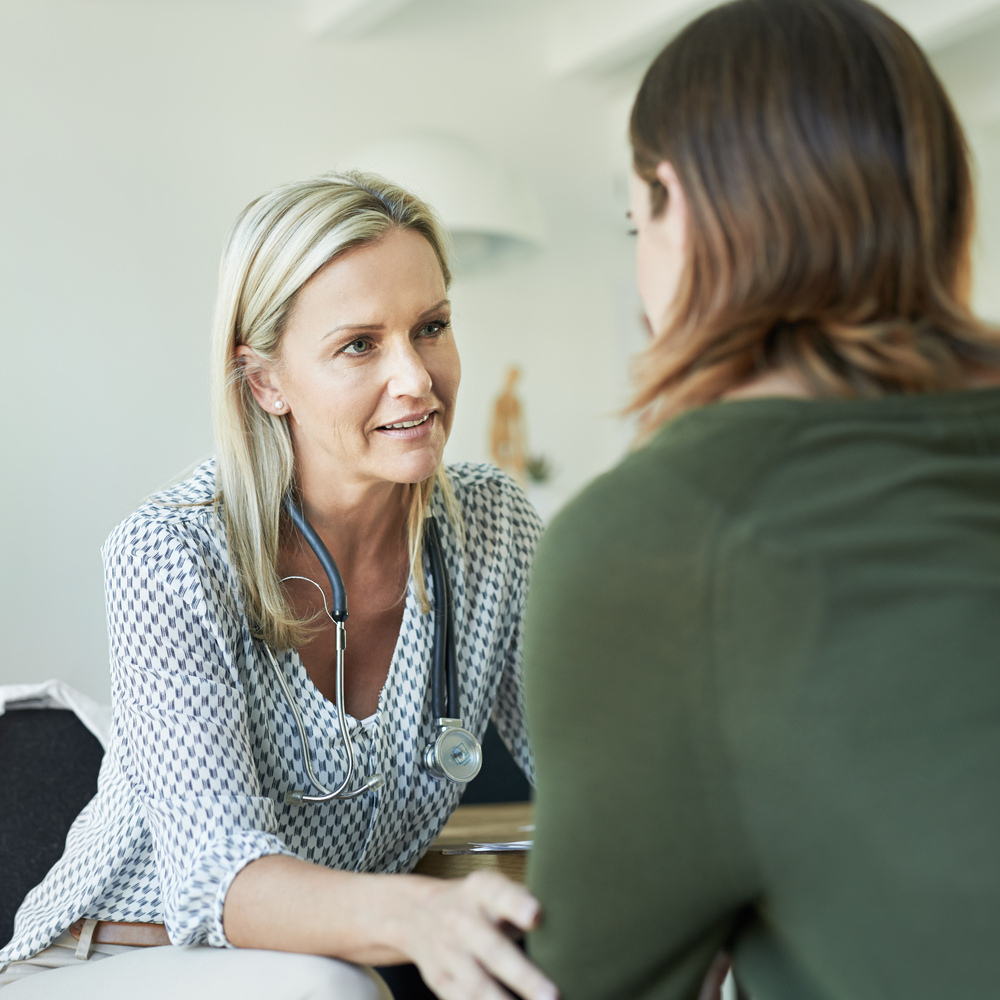 A female medical practitioner reassuring a female patient - How To Find An English-Speaking Doctor Abroad For Expats