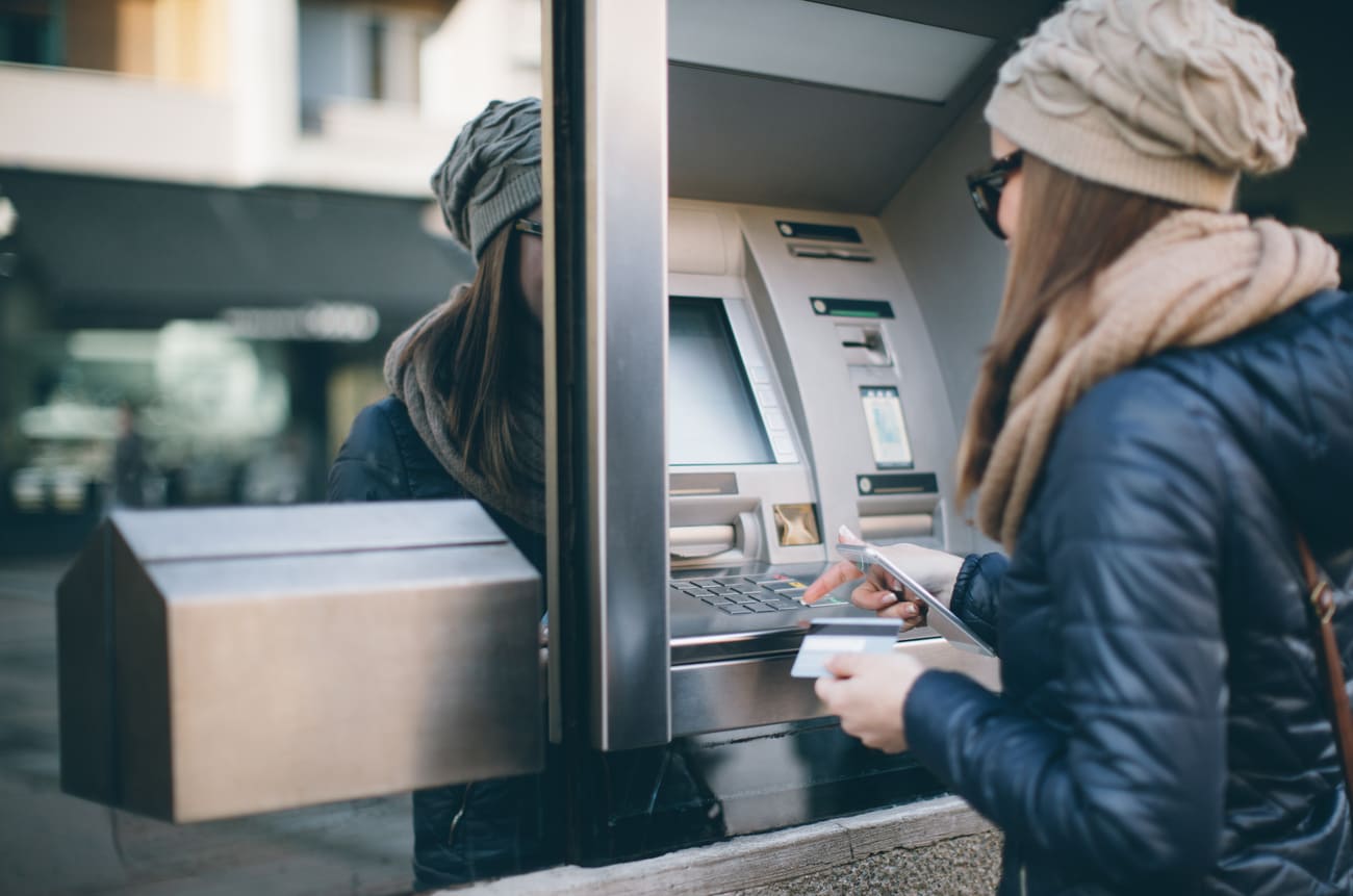 Young woman at a cash machine