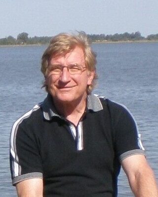 William Russell member, Andrew, sitting in front of the sea