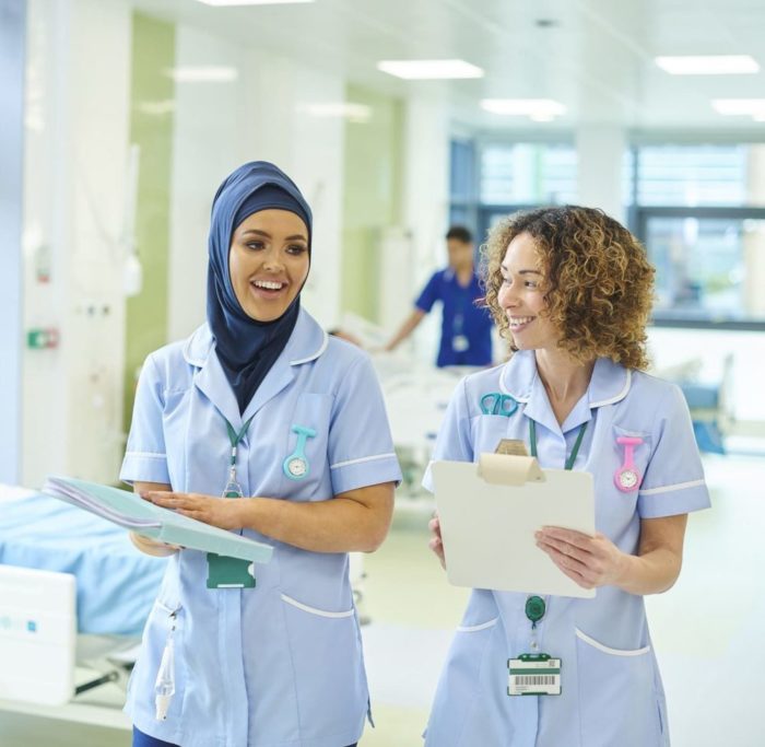 William Russell - Blog -Best Hospitals in the UK for Expats - happy nurse team - young nurse training on the ward
