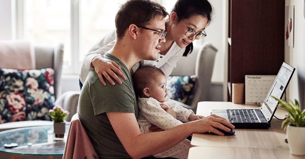 William Russell - International Maternity insurance - How to claim, family with baby on computer