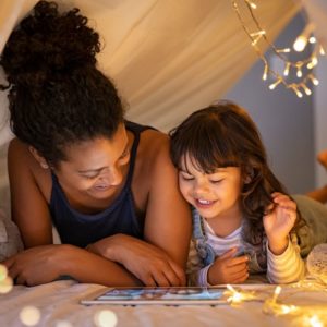 William Russell Global Life Insurance - mum and daughter watching movin in indoor tent small